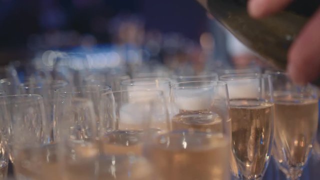 Pouring Glasses of Champagne from Bottle during Celebration at Dinner Party, Slow Motion