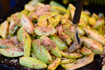 mango  with sugar ,salts and mixed dry chilli