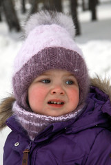 Child in lilac winter clothes looking right