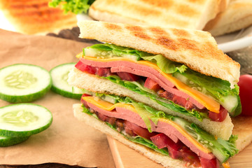 Sliced Grilled sandwiches bread with bacon , ham and cheese 