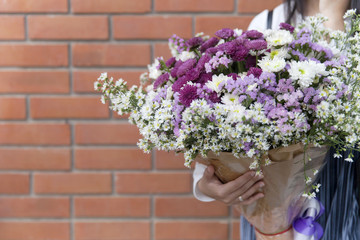 flower bouquet in lady hand for eduation completion congratulation to university graduated student