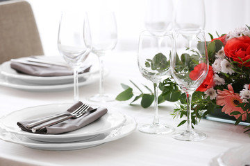 Elegant table setting with beautiful flowers, closeup