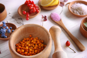 Natural ingredients for homemade cosmetics in wooden bowls, closeup