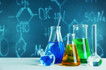 Test beakers and flasks on blackboard background