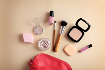 Cosmetic bag and makeup products on color   background