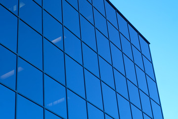 blue skyscraper office tower glass mirror windows and sky