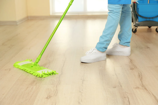 Close up view of woman moping floor at home