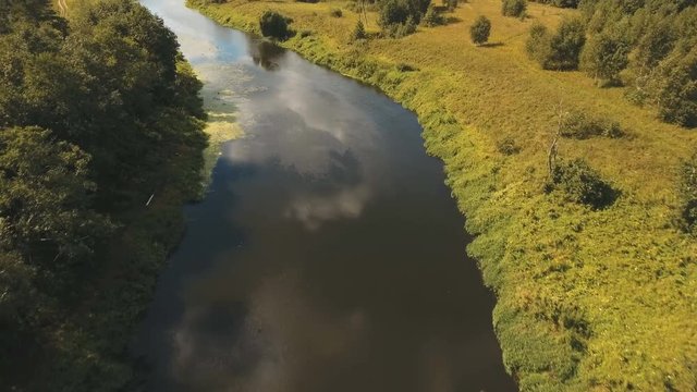 Landscape with river, forest, clouds, blue sky.Aerial view of the water surface of the river.Aerial video.4K,UHD Aerial Rural landscape.
