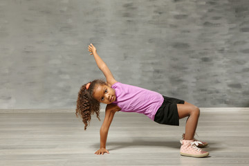 Cute African American girl in dance studio