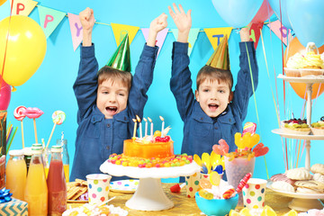 Cute little twins celebrating birthday at home