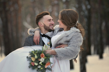 Happy wedding couple outdoors on winter day