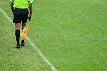 Assistant soccer referee running along side line