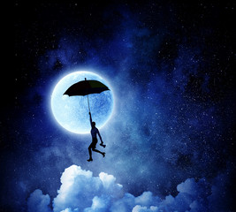 Woman flying on umbrella . Mixed media