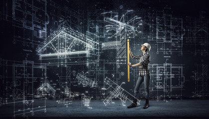 Builder woman taking measures . Mixed media