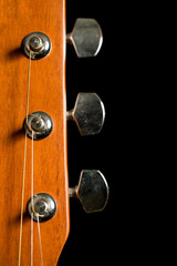 head of acoustic guitar on black background
