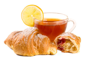 croissant and half with a cup of tea isolated on white background closeup