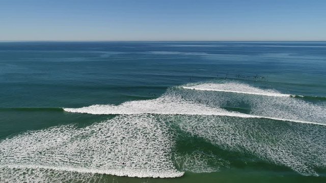 Aerial view of several layered ocean waves coming in. Video taken in Encinitas, California, USA.