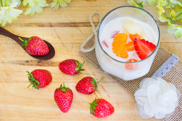 Milk Pudding with fruits in glass on wooden background. Milk Pudding decorate dessert bowl set on Wooden Table .
