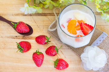 Milk Pudding with fruits in glass on wooden background. Milk Pudding decorate dessert bowl set on Wooden Table .