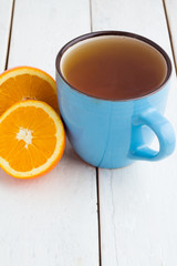 tea and oranges on a white background