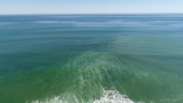 Slow rolling waves with lots of surfers waiting near Entinitas, California, USA.