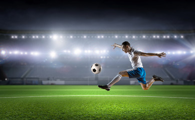 Obraz na płótnie Canvas Soccer player kicking ball . Mixed media
