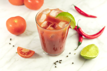 Bloody Mary cocktail with lime, tomatoes and chilis