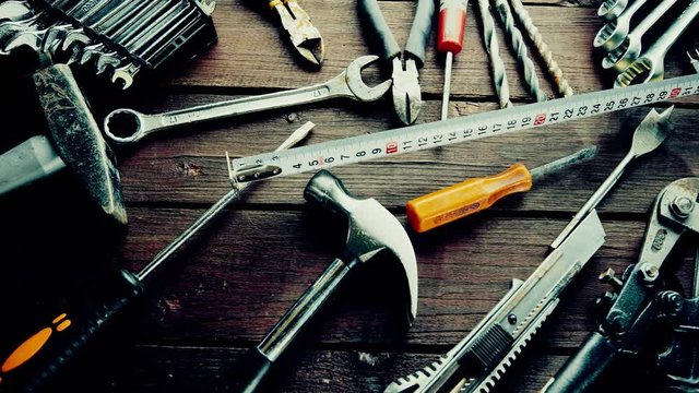 Many old rusty tools on repairman desk