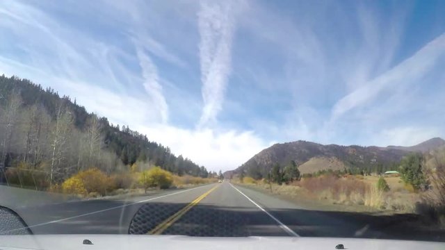 Timelapse hyperlapse of driving on a sunny november day, autumn colors and snowy mountains on route 395, near mono lake and lee vining, in California, United states of America