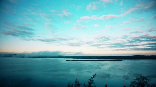 Fog over lake in the morning. Timelapse