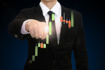 Businessman pointing on the trading graph of stock market