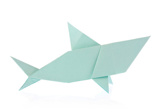 Paper origami shape - shark. The Japanese art of folding paper figures is a hobby, needlework.