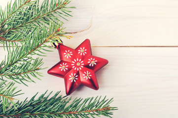 red Christmas tree toy in the form of stars on a fir branch