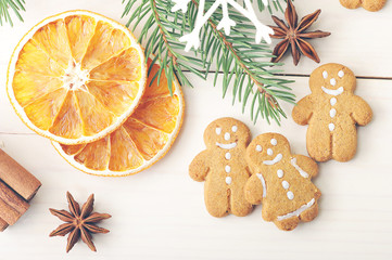 men gingerbread and dried oranges with Christmas tree branches