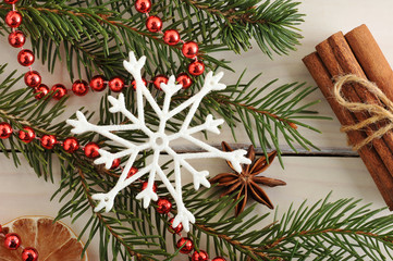 Christmas background - Christmas tree, cinnamon, beads and snowf