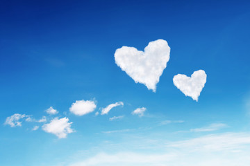 Naklejka na ściany i meble couple white heart shaped clouds on blue sky