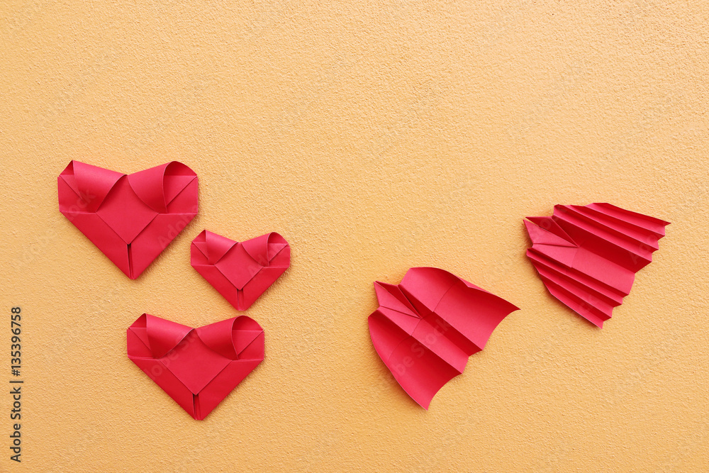 Poster three folding red paper hearts with bat and bird rocket on yello
