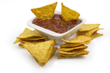 Tortilla chips with hot dip isolated on white background. Clipping path included in JPEG.