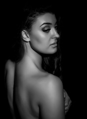 Naklejka premium silhouette of nude young beautiful woman on black background, black and white