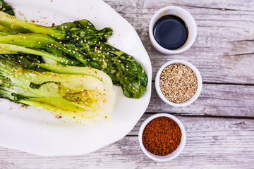 Fried Chinese cabbage Pak Choi on white plate. 