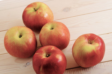red ripe apples on wooden white background