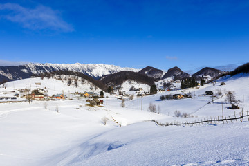 Fototapeta na wymiar winter landscape with a mountain village in Romania