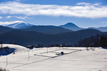 winter landscape with a mountain village in Romania