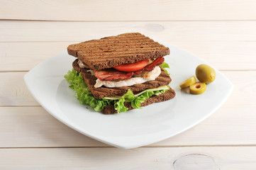 sandwich with chicken and bacon on plate