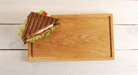 triangular sandwich on a wooden Board