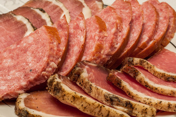 sliced cold meat appetizer. sausage of a salami and dried pork. closeup