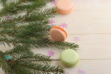 cake macarons with Christmas tree branches and snowflakes on woo