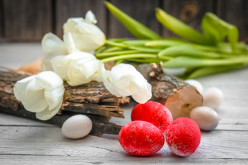 White tulips and red eggs