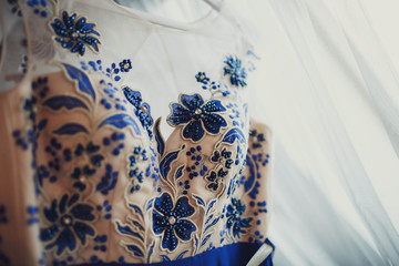 details of beautiful evening dress with blue flowers