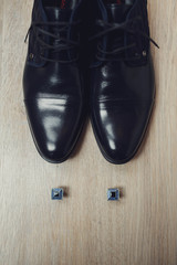 beautiful and silver cufflinks and black shoes of the groom